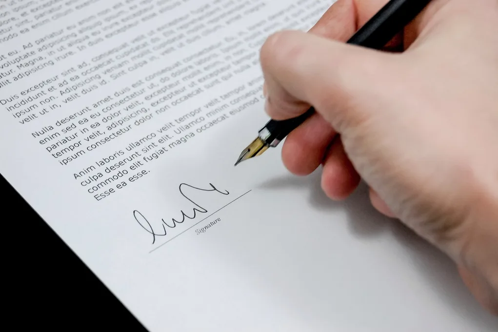 A handshake over signed loan documents